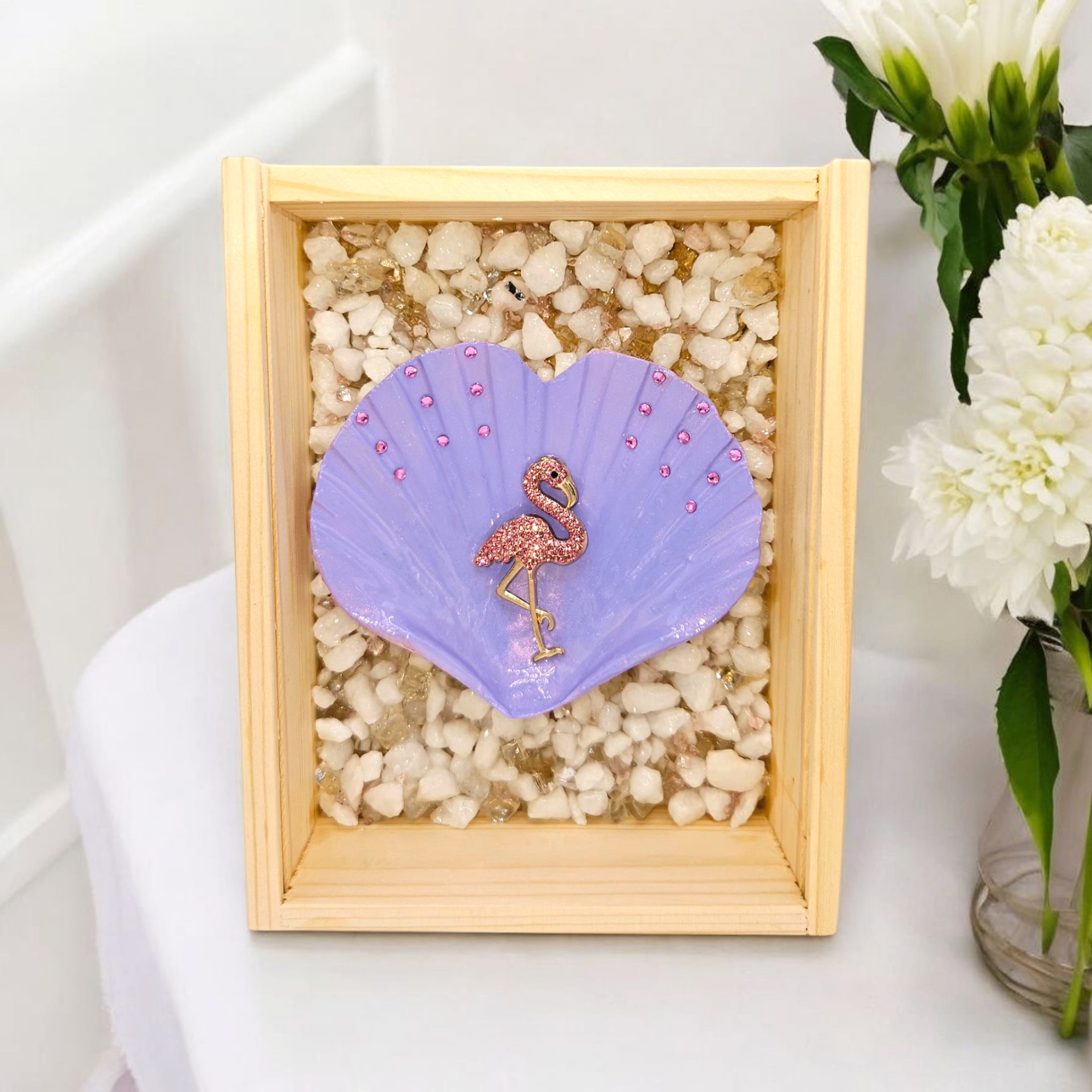 Wooden shadow box with a lavender heart shell centerpiece and pink flamingo embellishment.