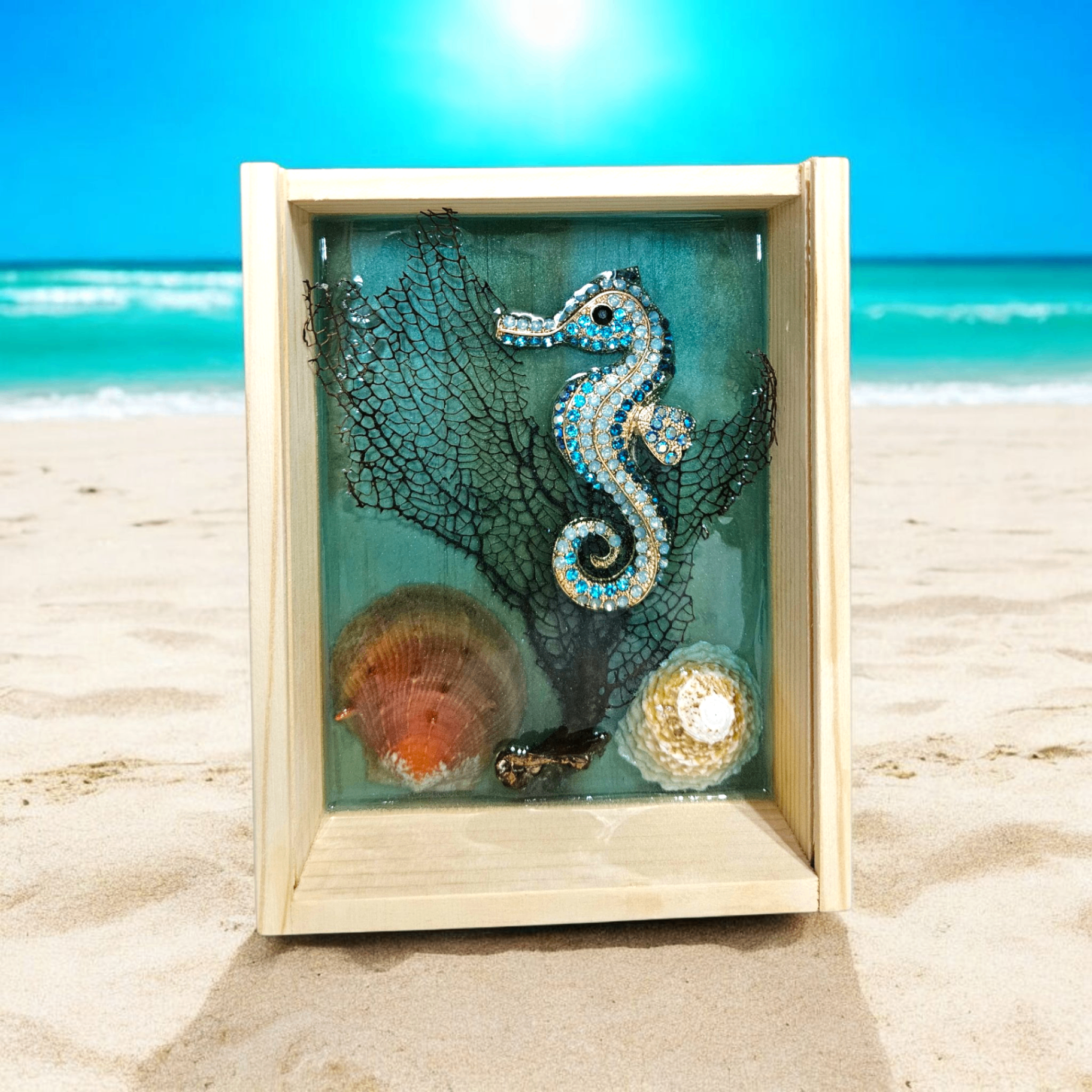 Wooden beach-inspired shadow box with a blue jeweled seahorse, sea fan coral, and shell accents.