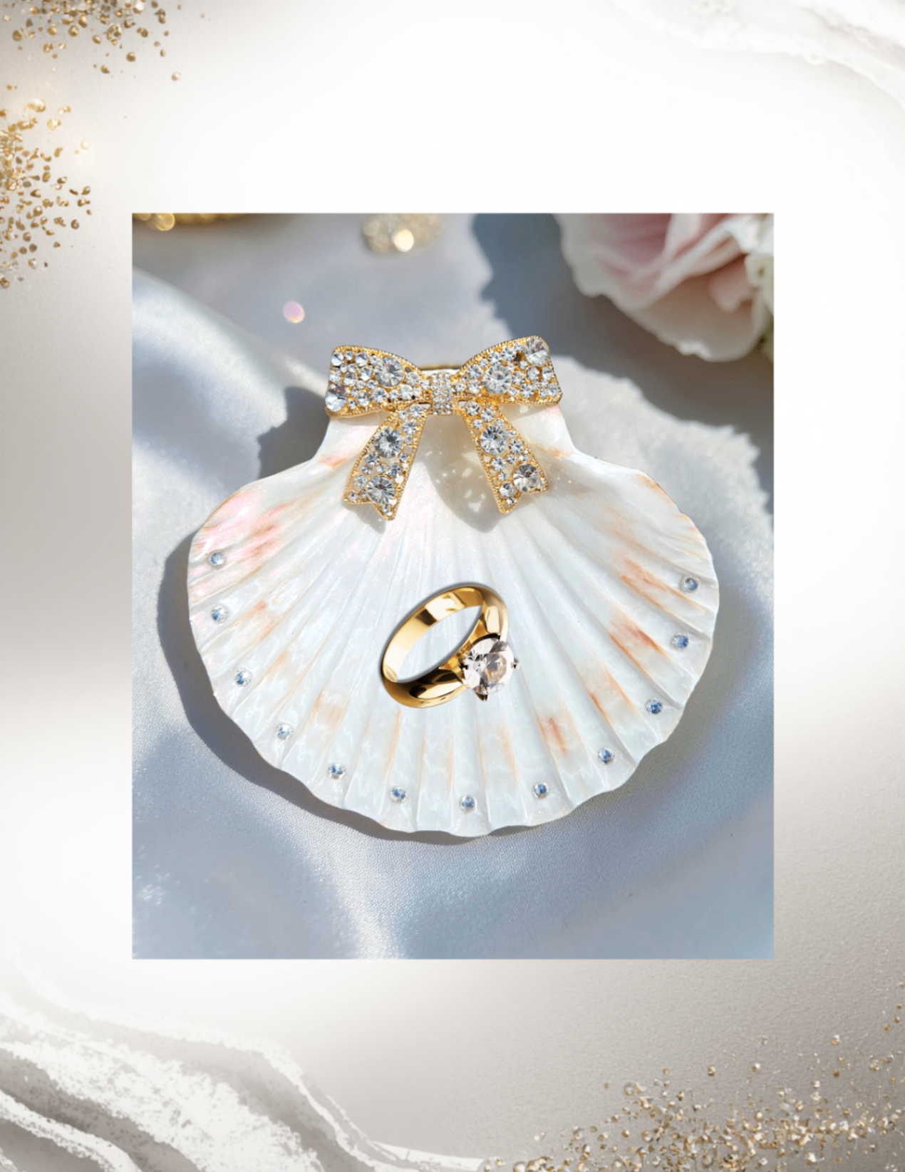 White shell ring dish with a jeweled bow and gold ring styling.